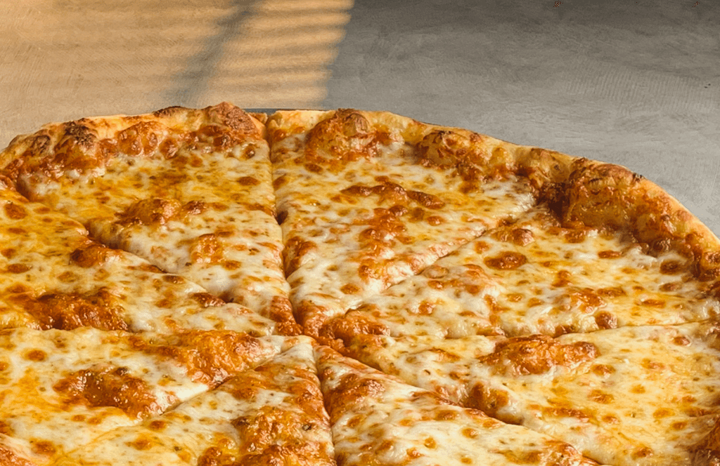 Large New York style cheese pizza with golden blistered crust and hand-tossed dough baked at Asaro's Pizzeria on Bee Ridge Road in Sarasota